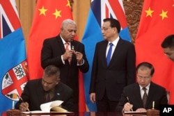 Fiji's Prime Minister Prime Minister Frank Bainimarama, top left, talks with Chinese Premier Li Keqiang (Nicolas Asfouri/Pool Photo via AP, File)