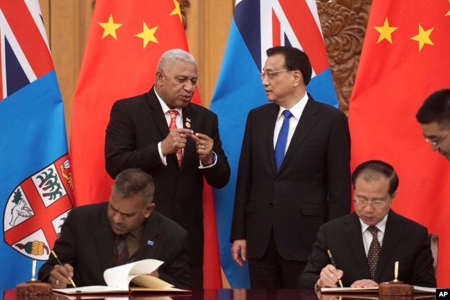 Fiji's Prime Minister Prime Minister Frank Bainimarama, top left, talks with Chinese Premier Li Keqiang (Nicolas Asfouri/Pool Photo via AP, File)