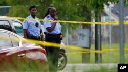 Investigators search the crime scene of a shooting at Xavier University in New Orleans, May 31, 2022. 