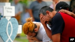 Layla Salazar's father, Vincent Salazar, weeps while kneeling in front of a cross with his daughter's name at a memorial site for the victims of this week's elementary school shooting in Uvalde, Texas, May 27, 2022.