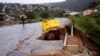 Water from heavy rains runs along a road, which was damaged during previous flooding, in kwaNdengezi near Durban, South Africa, May 22, 2022. 