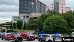 Emergency personnel work at the scene of a shooting at a medical clinic in Tulsa, Okla., June 1, 2022. 