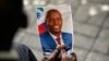 FILE - A person holds a photo of late Haitian President Jovenel Moise during his memorial ceremony at the National Pantheon Museum in Port-au-Prince, Haiti, July 20, 2021.