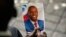 FILE - A person holds a photo of late Haitian President Jovenel Moise during his memorial ceremony at the National Pantheon Museum in Port-au-Prince, Haiti, July 20, 2021.