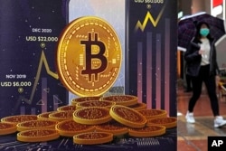 An advertisement for Bitcoin cryptocurrency is displayed on a street in Hong Kong, on Feb. 17, 2022. (AP Photo/Kin Cheung, File)