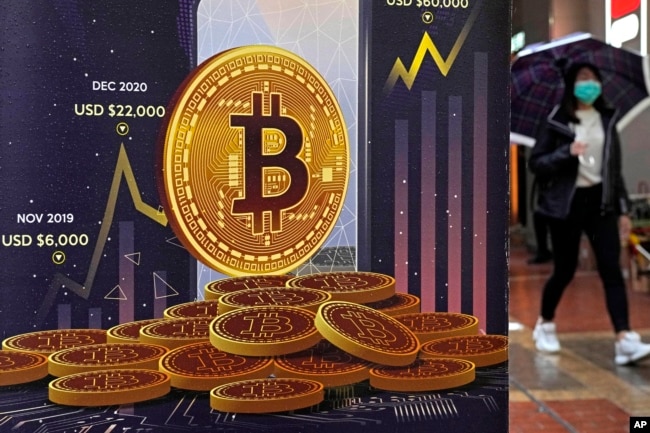 An advertisement for Bitcoin cryptocurrency is displayed on a street in Hong Kong, on Feb. 17, 2022. (AP Photo/Kin Cheung, File)