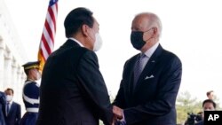 FILE - US President Joe Biden, right, meets with South Korean President Yoon Suk Yeol at the People's House, May 21, 2022, in Seoul.