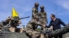 U.S. Ambassador to Poland Mark Brzezinski shakes hands with U.S. soldiers on a tank as troops from Poland, United States, France and Sweden take part in the DEFENDER-Europe 22 military exercise, in Poland, May 19, 2022.