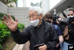 Catholic Cardinal Joseph Zen leaves after an appearance at a court in Hong Kong as he was charged in relation to their past fundraising for activists, May 24, 2022.
