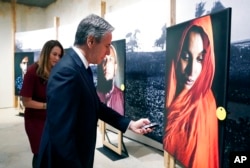 FILE - Secretary of State Antony Blinken tours the "Burma's Path To Genocide" exhibit at the United States Holocaust Memorial Museum, in Washington, March 21, 2022. Blinken says the violent repression of the largely Muslim Rohingya population in Myanmar amounts to genocide.