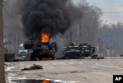 Kendaraan lapis baja Rusia terbakar di Kharkiv, kota terbesar kedua di Ukraina, 27 Februari 2022. (Foto: AP)