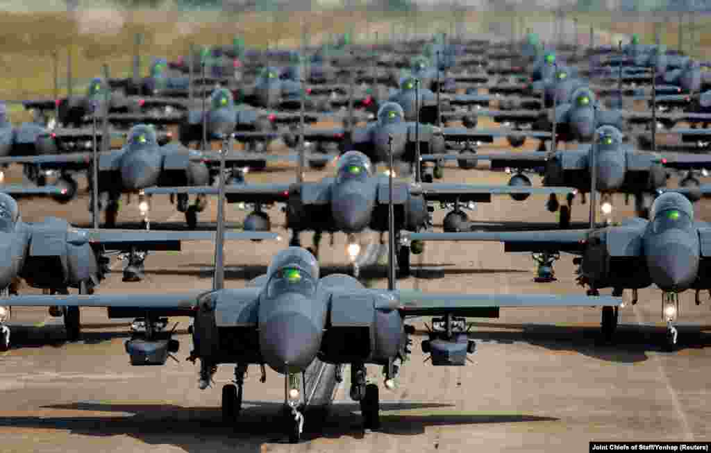 South Korean Air Force F-15K fighter jets taxi into a position during an "elephant walk" at an unidentified air base, South Korea, May 24, 2022.