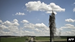 A mortar explodes next to the road leading to the city of Lysychansk in the eastern Ukranian region of Donbas, May 23, 2022, amid Russian invasion of Ukraine.