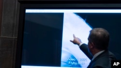 Deputy Director of Naval Intelligence Scott Bray points to a video display of a UAP during a hearing of the House committee hearing on "Unidentified Aerial Phenomena," on Capitol Hill, Tuesday, May 17, 2022, in Washington. (AP Photo/Alex Brandon)
