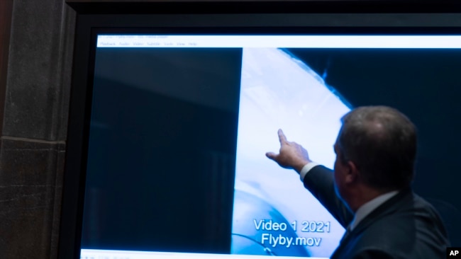 Deputy Director of Naval Intelligence Scott Bray points to a video display of a UAP during a hearing of the House committee hearing on "Unidentified Aerial Phenomena," on Capitol Hill, Tuesday, May 17, 2022, in Washington. (AP Photo/Alex Brandon)

