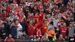 Liverpool's Mohamed Salah celebrates after scoring his goal during the Premier League soccer match between Liverpool and Wolverhampton.