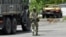 FILE - A Russian serviceman patrols a street in Kherson, amid Russia's ongoing invasion of Ukraine, May 20, 2022.