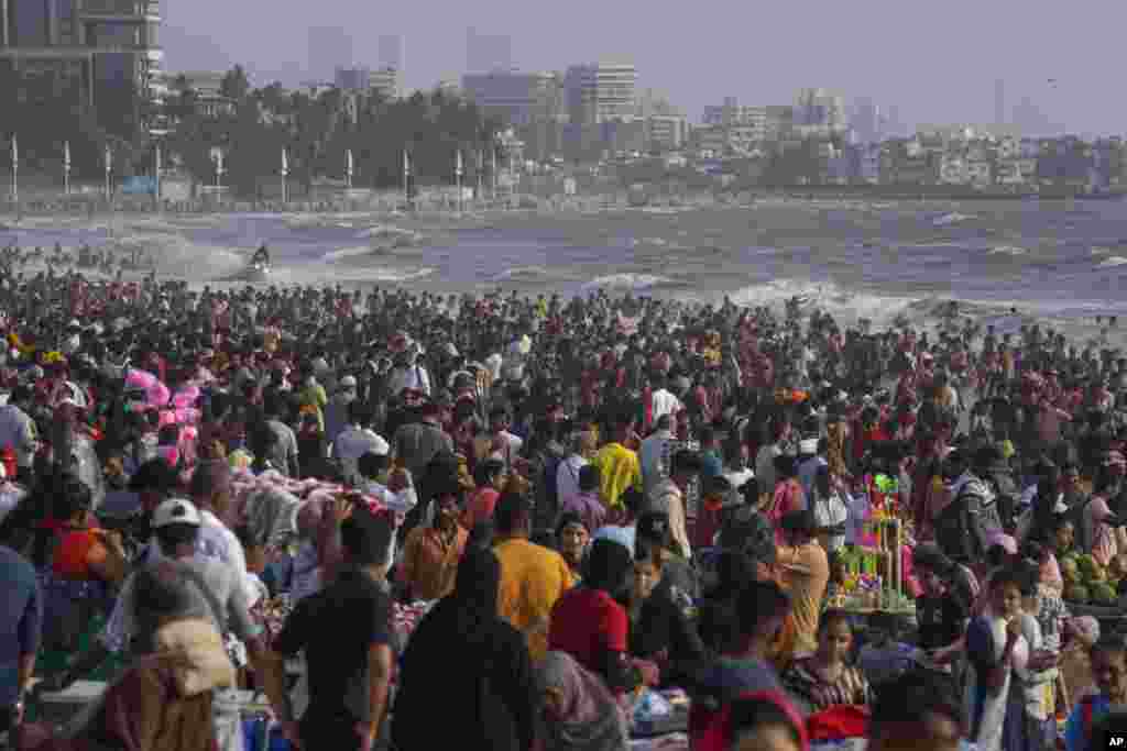 People crowd the Juhu beach on the Arabian Sea coast on a hot and humid day in Mumbai, India.