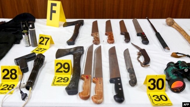 FILE - Bladed weapons seized as a result of the dismantling of an Islamic State group-affiliated cell that was planning suicide bombings in Morocco are shown during a Sept. 11, 2020, press conference by the director of Morocco's Central Bureau of Judicial Investigation.