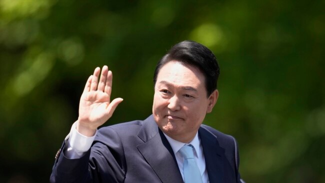 FILE -South Korea's new President Yoon Suk Yeol waves from a car after the Presidential Inauguration outside the National Assembly in Seoul, South Korea, May 10, 2022. This week, he will represent South Korea at the NATO summit in Madrid.