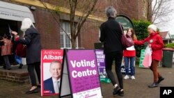 Voters walk into a pre-polling booth in Sydney, May 20, 2022. 