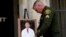 Orange County Sheriff's Sgt. Scott Steinle displays a photo of Dr. John Cheng, a 52-year-old victim who was killed in Sunday's shooting at Geneva Presbyterian Church, during a news conference in Santa Ana, Calif., May 16, 2022. 