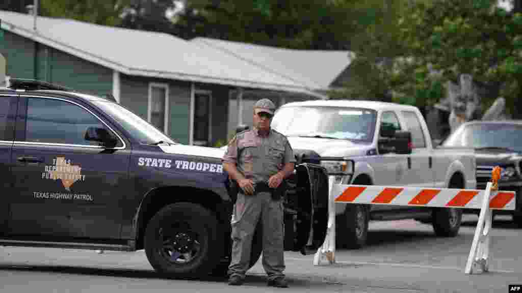 A state trooper stands seen outside of Robb Elementary School in Uvalde, Texas, May 24, 2022.