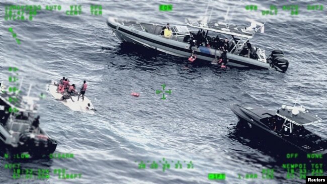 Rescue craft arrive on the scene after a migrant vessel capsized north of Desecheo Island, Puerto Rico, May 12, 2022, in a still image from surveillance aircraft video. (U.S. Coast Guard via Reuters)