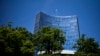 FILE - The UN flag wave on top of an UN building in Geneva, June 14, 2021. A veteran Russian diplomat to the U.N. Office at Geneva handed in his resignation before sending a scathing letter to foreign colleagues inveighing against Russia's invasion of Ukr