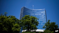 FILE - The UN flag wave on top of an UN building in Geneva, June 14, 2021. A veteran Russian diplomat to the U.N. Office at Geneva handed in his resignation before sending a scathing letter to foreign colleagues inveighing against Russia's invasion of Ukraine.