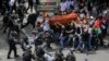 Israeli police confront mourners as they carry the casket of slain Al Jazeera veteran journalist Shireen Abu Akleh during her funeral in east Jerusalem.