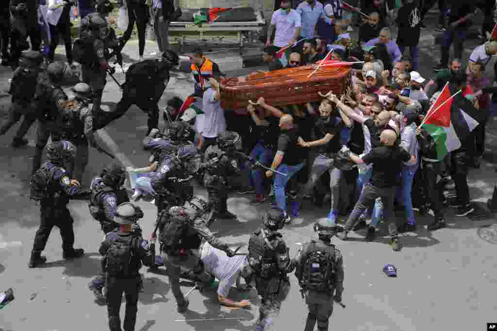 Israeli police confront mourners as they carry the casket of Al Jazeera reporter Shireen Abu Akleh during her funeral in east Jerusalem.