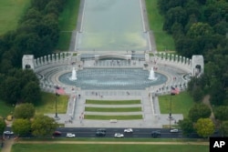 FILE - Traffic passes the World War II Memorial on the National Mall in Washington, Wednesday, Sept. 22, 2021. (AP Photo/Patrick Semansky)