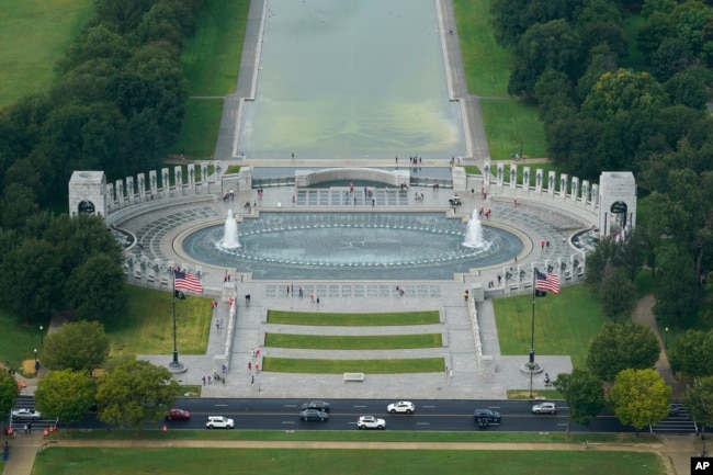 FILE - Traffic passes the World War II Memorial on the National Mall in Washington, Wednesday, Sept. 22, 2021. (AP Photo/Patrick Semansky)