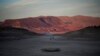 A formally sunken boat sits on cracked earth hundreds of feet from what is now the shoreline on Lake Mead at the Lake Mead National Recreation Area, near Boulder City, Nev. 