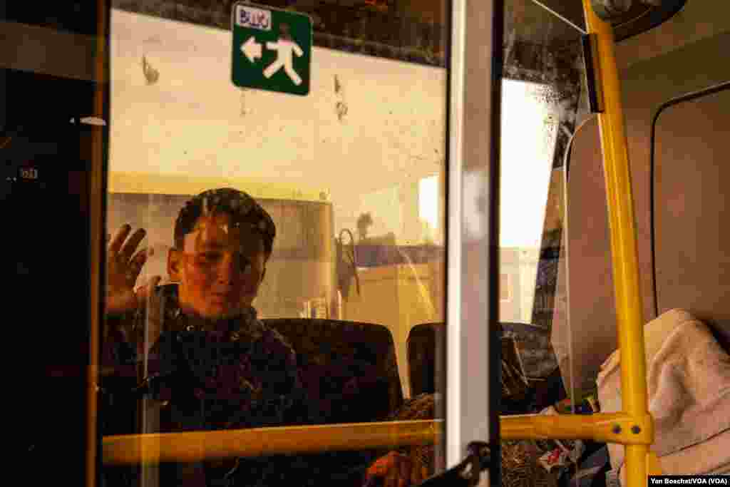 A young boy, who spent the last weeks inside the shelters of the Azovstal steel works, waits in a bus to be taken to a hotel after traveling for two days in a convoy organized by the U.N. and the International Red Cross from Mariupol to Zaporizhzhia, May 