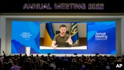 FILE: Ukrainian President Volodymyr Zelenskyy is seen on a screen as he addresses the audience from Kyiv during the World Economic Forum in Davos, Switzerland, May 23, 2022. 