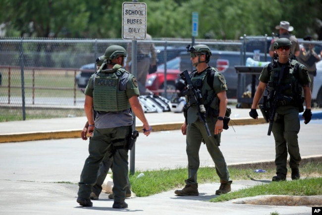 Law enforcement personnel stand outside Robb Elementary School following a shooting, Tuesday, May 24, 2022, in Uvalde, Texas. (AP Photo/Dario Lopez-Mills)