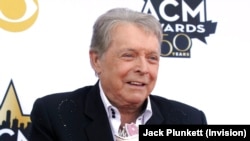 FILE - Mickey Gilley poses with the Triple Crown Award on the red carpet at the 50th annual Academy of Country Music Awards at AT&T Stadium in Arlington, Texas, April 19, 2015.