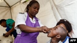 FILE - A Zimbabwean medical staff gives a young boy a vaccine against cholera during a vaccination campaign, in Harare, Zimbabwe. Taken Oct. 5, 2018.