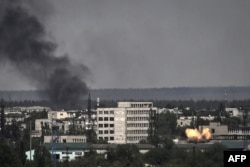 A photograph shows an explosion in the city of Severodonetsk during heavy fightings between Ukrainian and Russian troops at eastern Ukrainian region of Donbas on May 30, 2022. (Photo by ARIS MESSINIS / AFP)