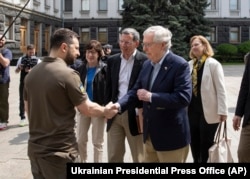 Ukrainian President Volodymyr Zelenskyy, on the left, shakes hands with the minority leader of the US Senate, Mitch McConnell, R-Ky., In Kyiv on May 14, 2022.