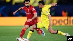 Liverpool's Mohamed Salah challenges Villarreal's Francis Coquelin during the Champions League semi final football match, May 3, 2022.