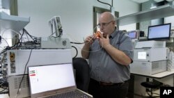 Hershtik demonstrates his company's product, which he says can detect certain diseases by analyzing a patient's breath, at the company's office in Rehovet, Israel, May 3, 2022.