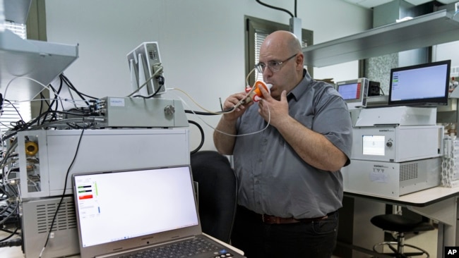 Hershtik demonstrates his company's product, which he says can detect certain diseases by analyzing a patient's breath, at the company's office in Rehovet, Israel, May 3, 2022.