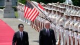 U.S. President Joe Biden, right, and Japan's Prime Minister Fumio Kishida review an honor guard during a welcome ceremony for President Biden, at the Akasaka Palace state guest house in Tokyo, Japan, May 23, 2022. 