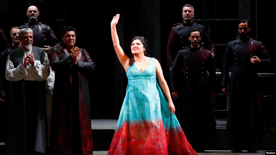 FILE - Russian operatic soprano Anna Netrebko acknowledges applause at the end of a performance at La Scala opera house in Milan, Italy, Dec. 7, 2019.