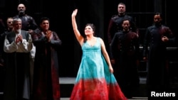 FILE - Russian operatic soprano Anna Netrebko acknowledges applause at the end of a performance at La Scala opera house in Milan, Italy, Dec. 7, 2019.