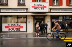 People gather in front of the so-called Russian War Crimes House alongside the World Economy Forum in Davos, Switzerland, May 22, 2022.
