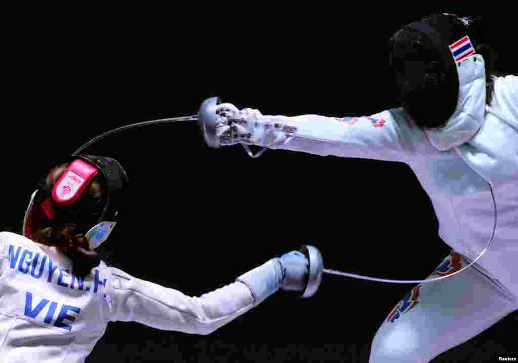 Vietnam's Phuong Kim Nguyen in action against Thailand's Pacharaporn Vasanasomsithi during the Women's Espee Team semi final fencing during the SEA Games in Hanoi, Vietnam, May 16, 2022.